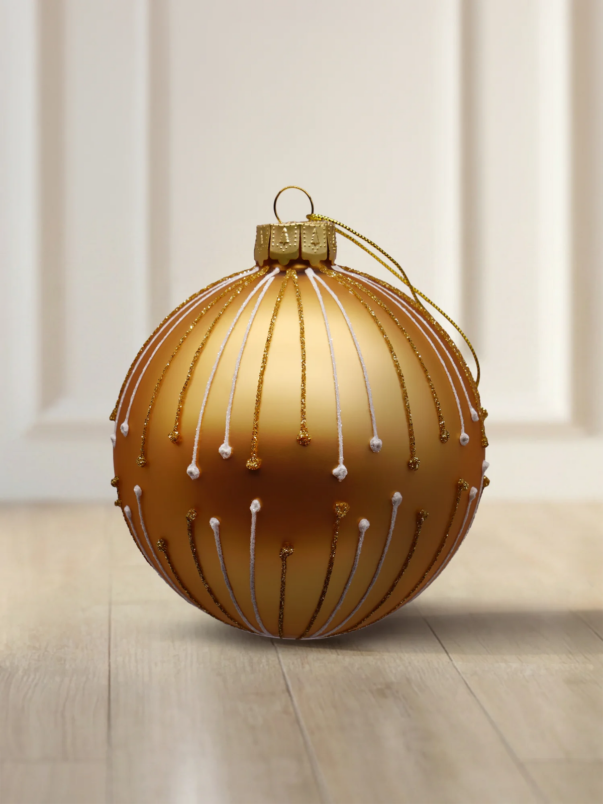 ArtiTree glass bauble 10 cm in matte gold with glitter lines and white dots in a ray pattern