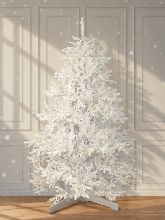 White artificial Christmas tree, 180 cm, with warm white LED lights and a white stand in front of a light-colored wall.