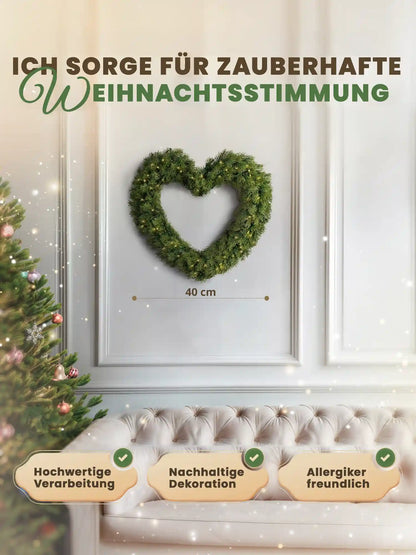 Heart-shaped artificial Christmas wreath, 40cm, by ArtiTree, with measurements shown, on a white wall