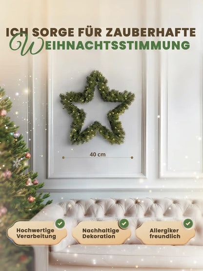 Artificial star-shaped Christmas wreath, 40cm, by ArtiTree, with dimensions shown on a white wall next to a decorated Christmas tree