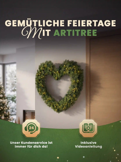 Artificial Christmas wreath in a heart shape with LED lights hanging decoratively on a light-colored wall in a cozy living room