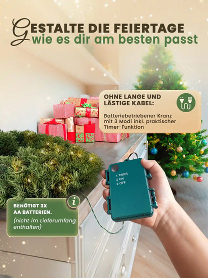 Battery-powered heart-shaped Christmas wreath by ArtiTree with timer function – a hand holds the controller while the wreath rests on a chest of drawers